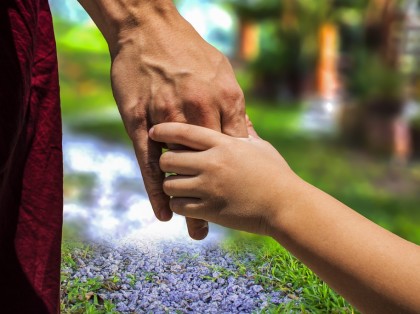adult holding childs hand